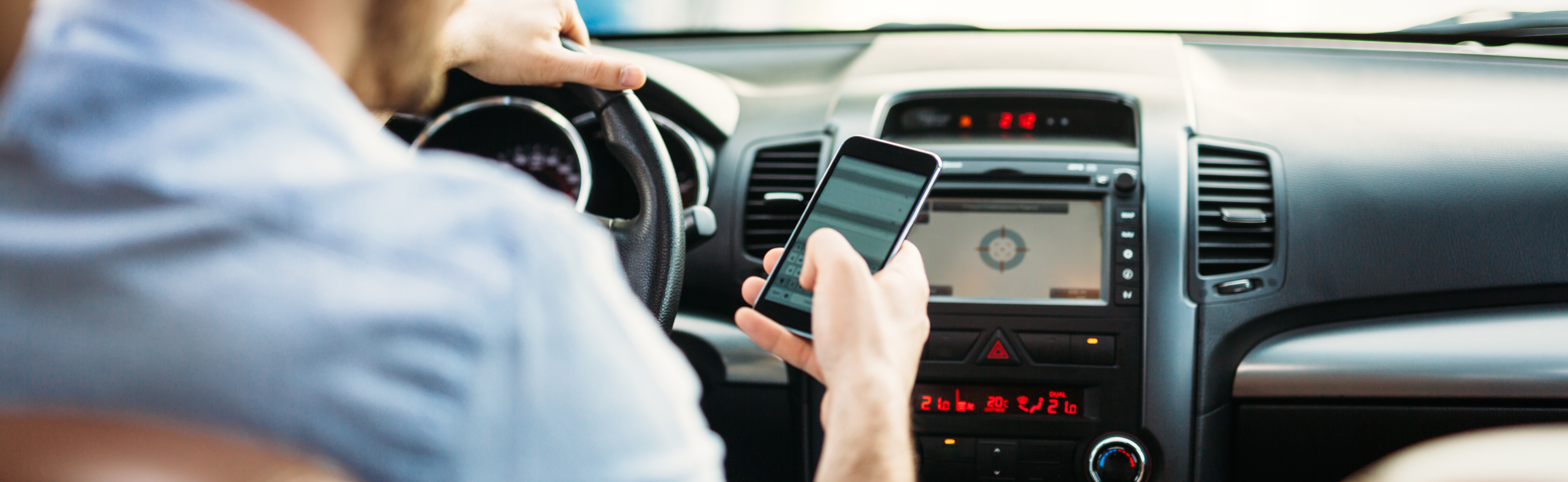 Driver using his phone behind the wheel