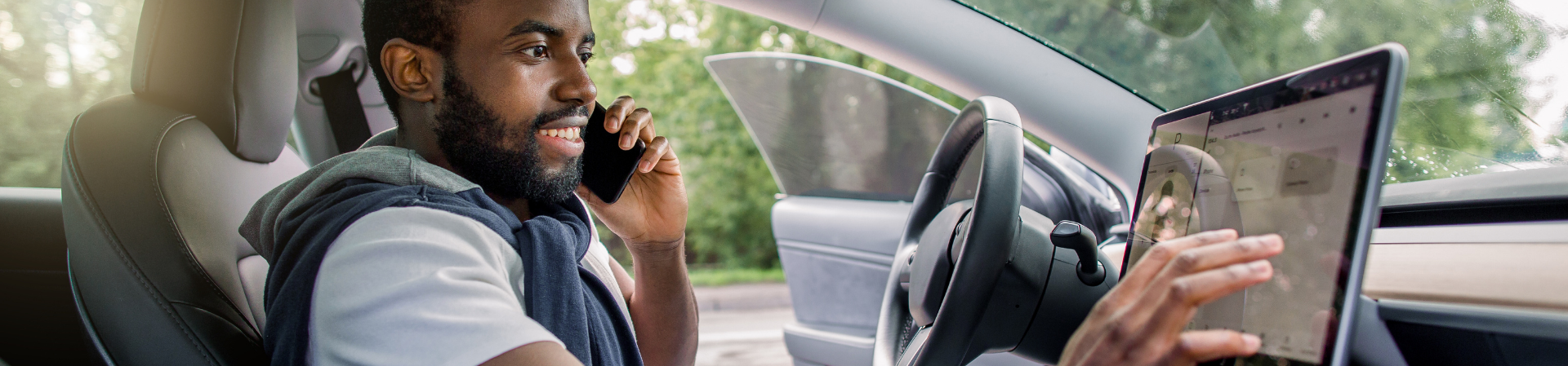 Man using phone and screen in car