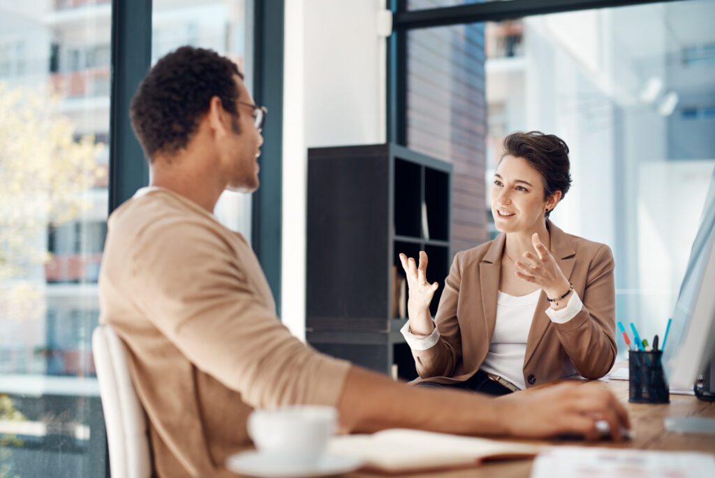 Mentor, training and a woman manager with an employee in the office for coaching on company vision. Management, meeting and a female business person talking to a professional male colleague at work.